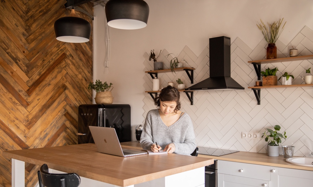 a woman is working on laptop