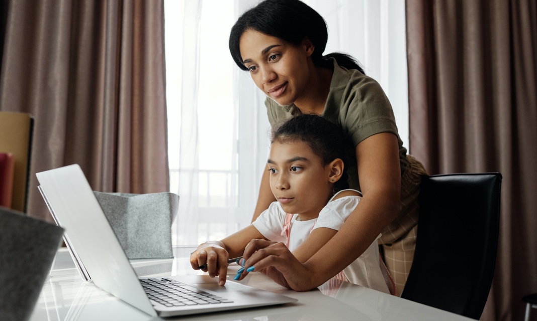 mother and daughter working on a laptop