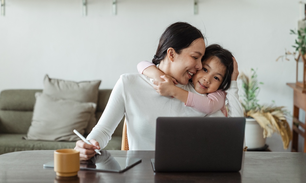 a woman and a dauther in front of a laptop
